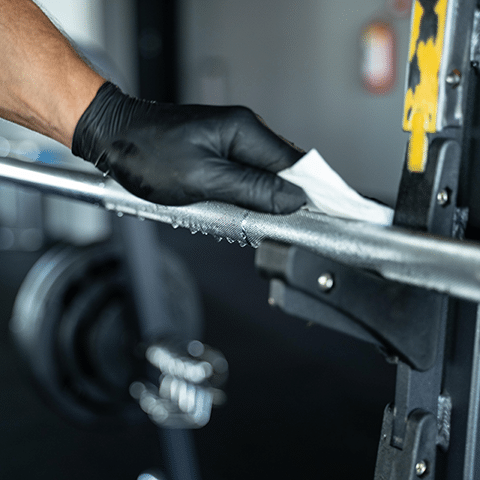 Image of a gloved hand cleaning a silver bar